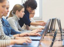 Female students learning computer programming